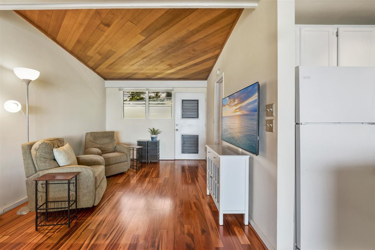 Lower Honoapiilani Road, Unit 210 Lahaina, HI 96761 - Photo 12 of 29 a living room with furniture and a flat screen tv