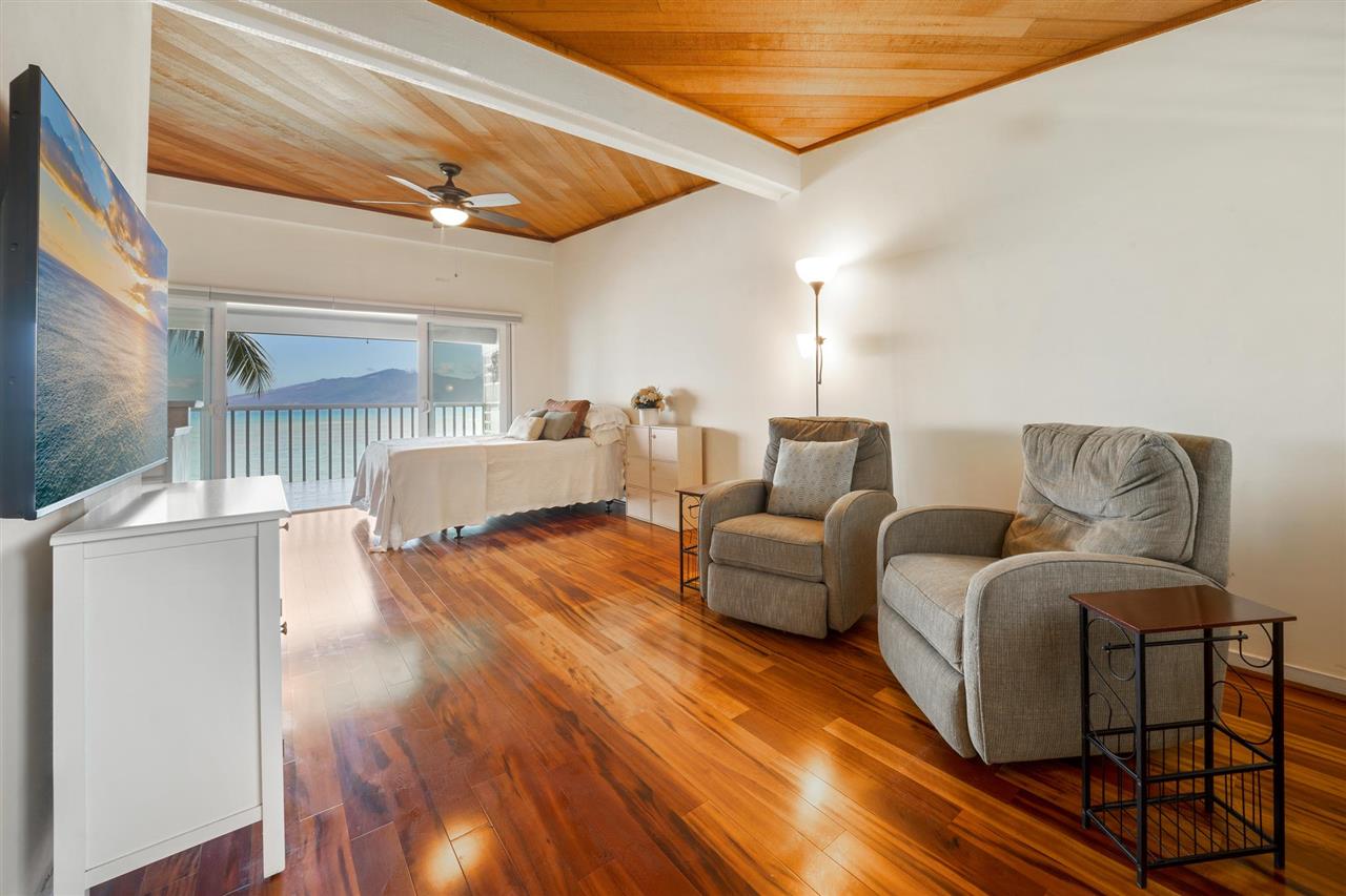 Lower Honoapiilani Road, Unit 210 Lahaina, HI 96761 - Photo 2 of 29 a living room with furniture and a wooden floor