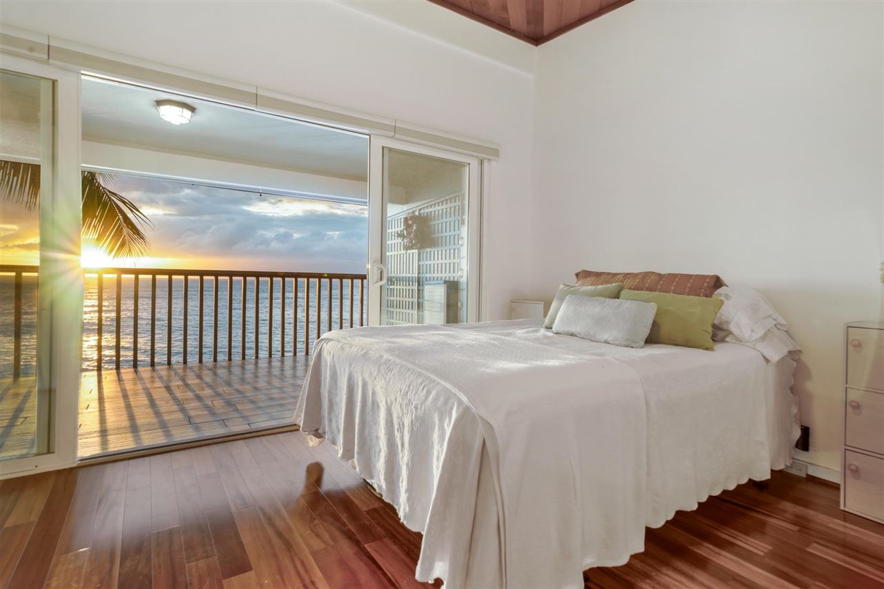 Lower Honoapiilani Road, Unit 210 Lahaina, HI 96761 - Photo 9 of 29 a bedroom with a bed and wooden floor