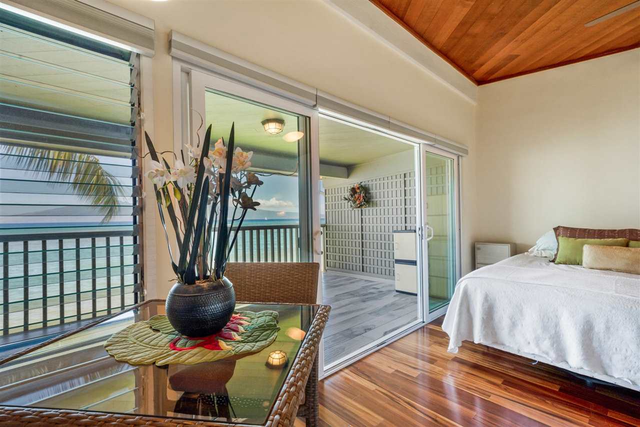 Lower Honoapiilani Road, Unit 210 Lahaina, HI 96761 - Photo 10 of 29 a bedroom with a bed and wooden floor
