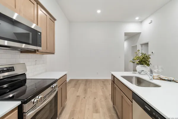 a kitchen with a sink and microwave