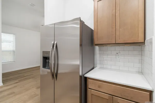 a kitchen with a refrigerator and cabinets