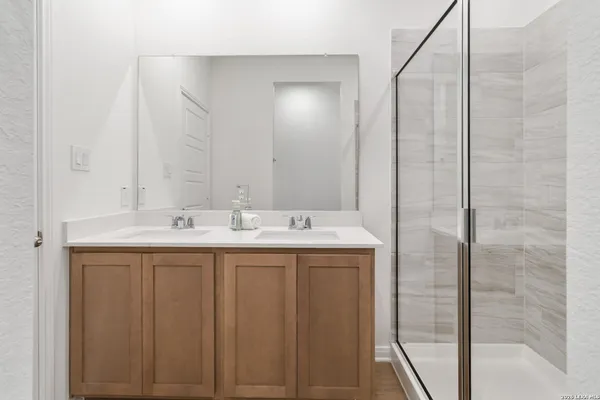 a bathroom with a double vanity sink and a mirror