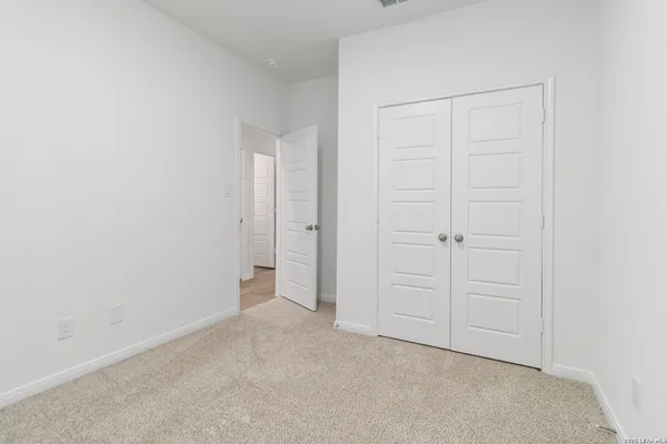 an empty room with closet area