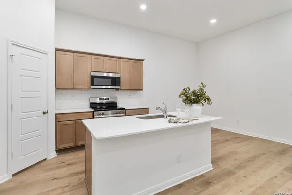 a kitchen with a sink and a refrigerator