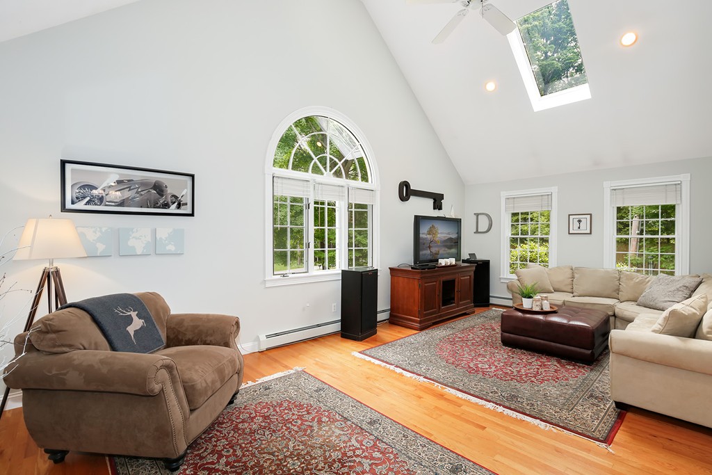 117 Perkins Row Topsfield, MA 01983 - Photo 11 of 28 a living room with furniture and a flat screen tv
