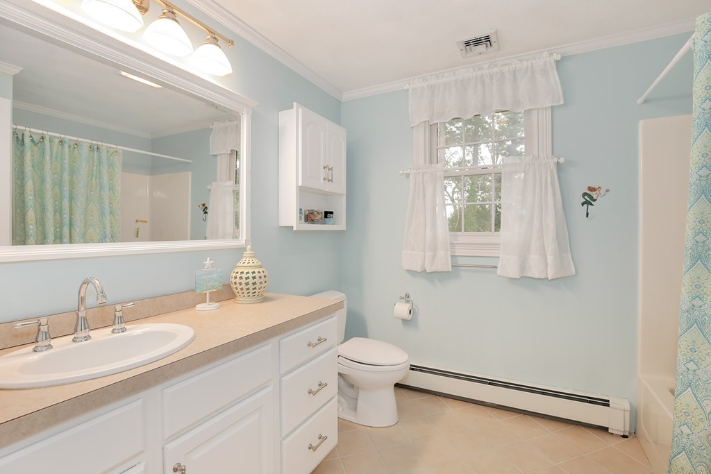 117 Perkins Row Topsfield, MA 01983 - Photo 18 of 28 a bathroom with a double vanity sink toilet and a mirror