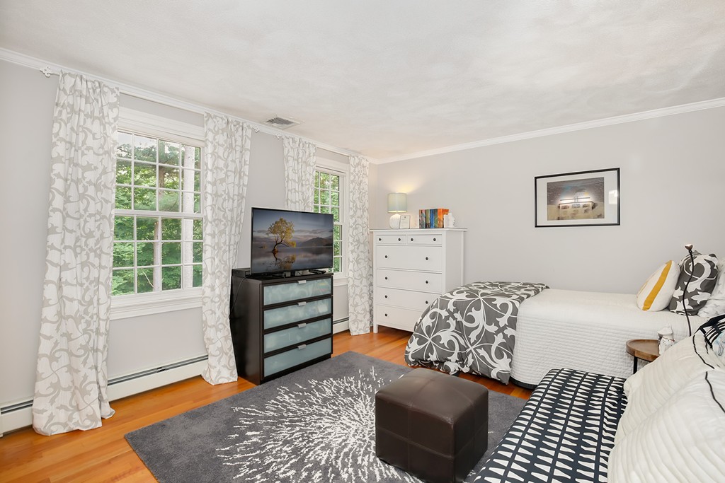 117 Perkins Row Topsfield, MA 01983 - Photo 19 of 28 a bedroom with a bed and a window