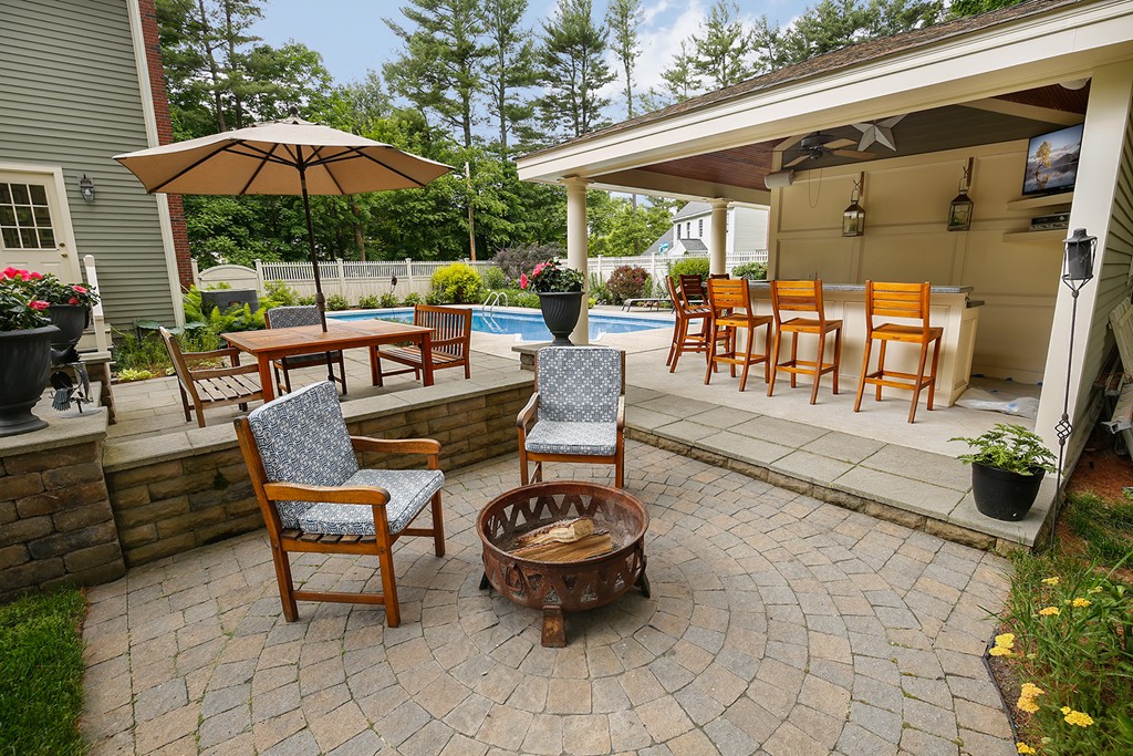 117 Perkins Row Topsfield, MA 01983 - Photo 28 of 28 a view of a patio with a table and chairs under an umbrella