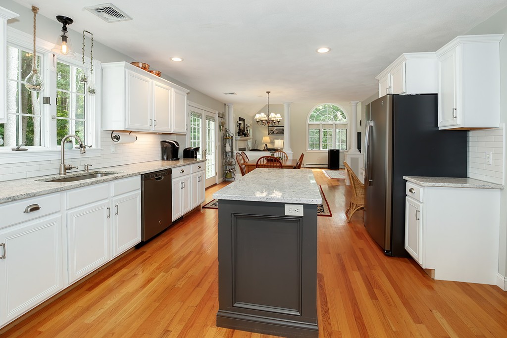 117 Perkins Row Topsfield, MA 01983 - Photo 7 of 28 a kitchen with stainless steel appliances granite countertop a sink stove and refrigerator