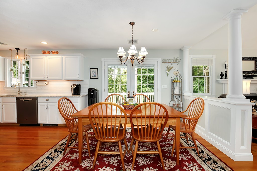 117 Perkins Row Topsfield, MA 01983 - Photo 9 of 28 a view of a dining room with furniture a chandelier and wooden floor