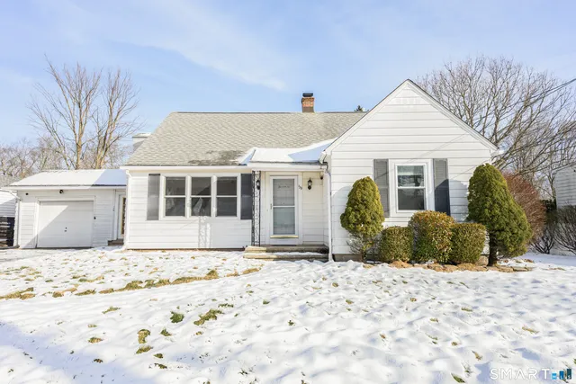 a view of a house with snow on the road
