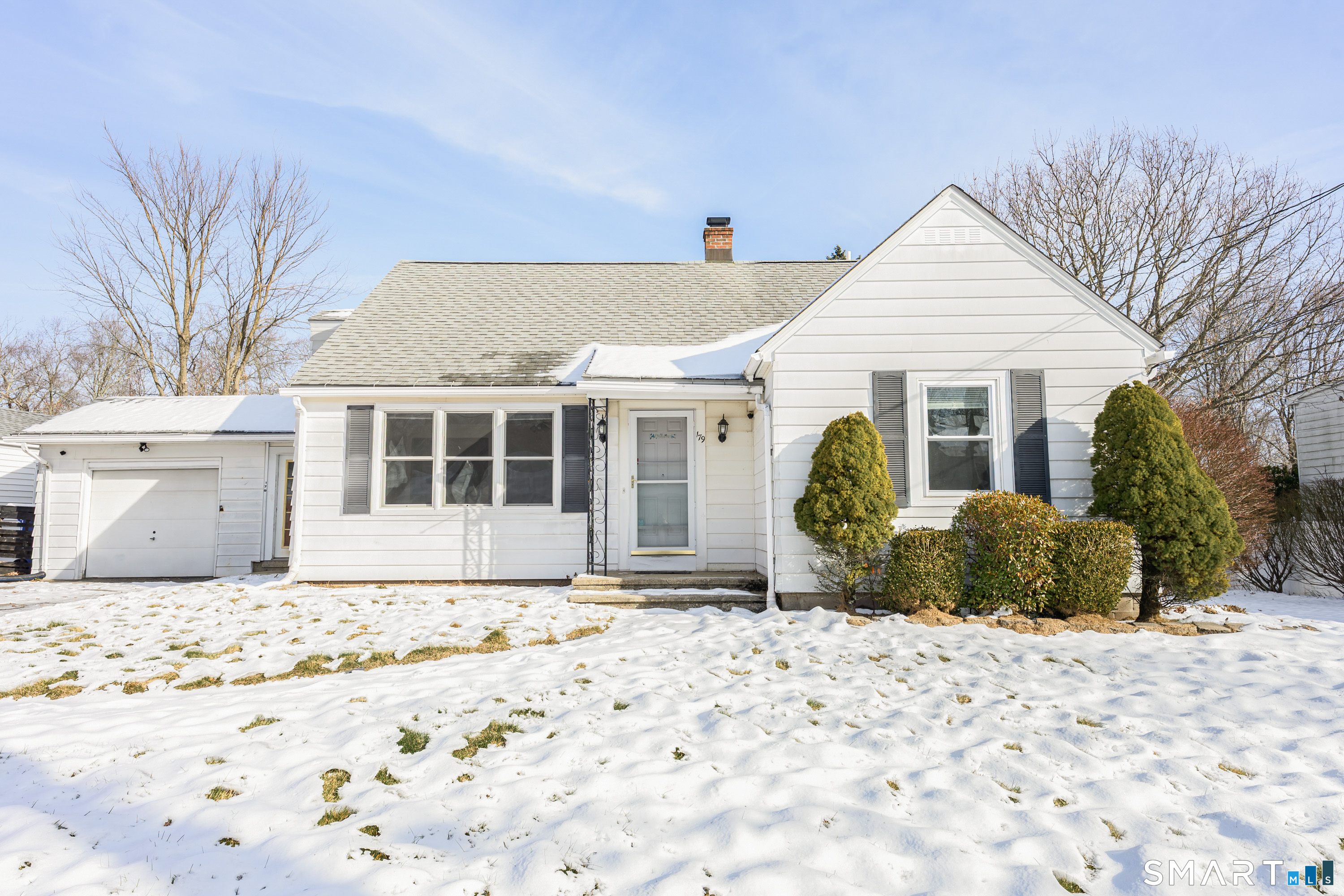 a view of a house with snow on the road