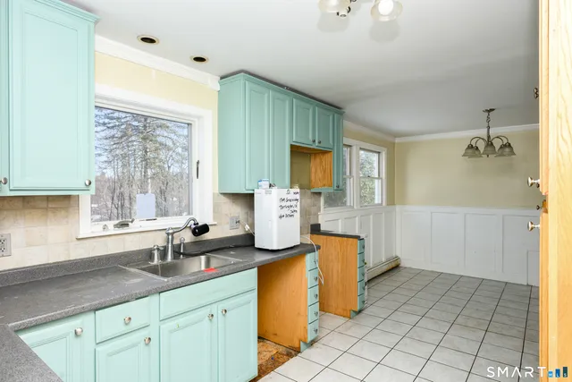 a kitchen with sink cabinets and window
