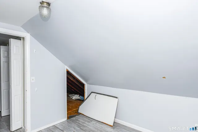 a view of staircase with wooden floor