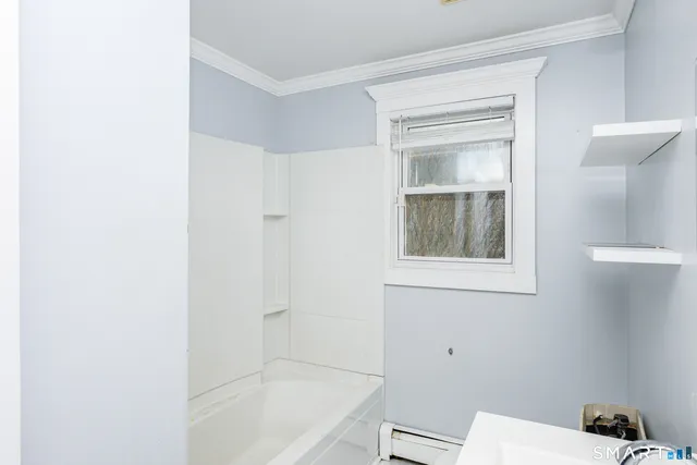 a bathroom with a bathtub and window