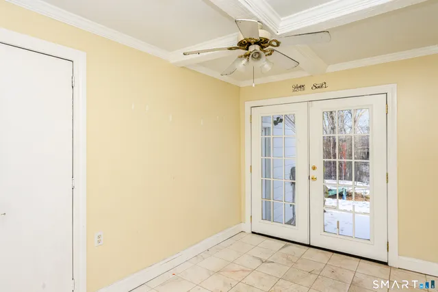 a view of a livingroom with a ceiling fan and window
