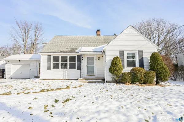 a front view of house with yard and outdoor seating