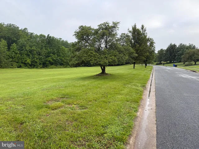a lake view with a big yard