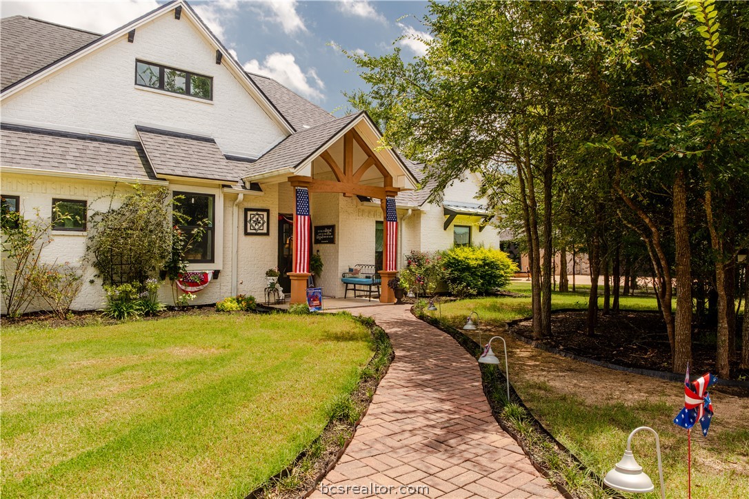 5036 Glory Road Bryan, TX 77808 - Photo 2 of 50 Beautiful pathway flows to luxe home. Custom stained cedar exterior post that frames the entry