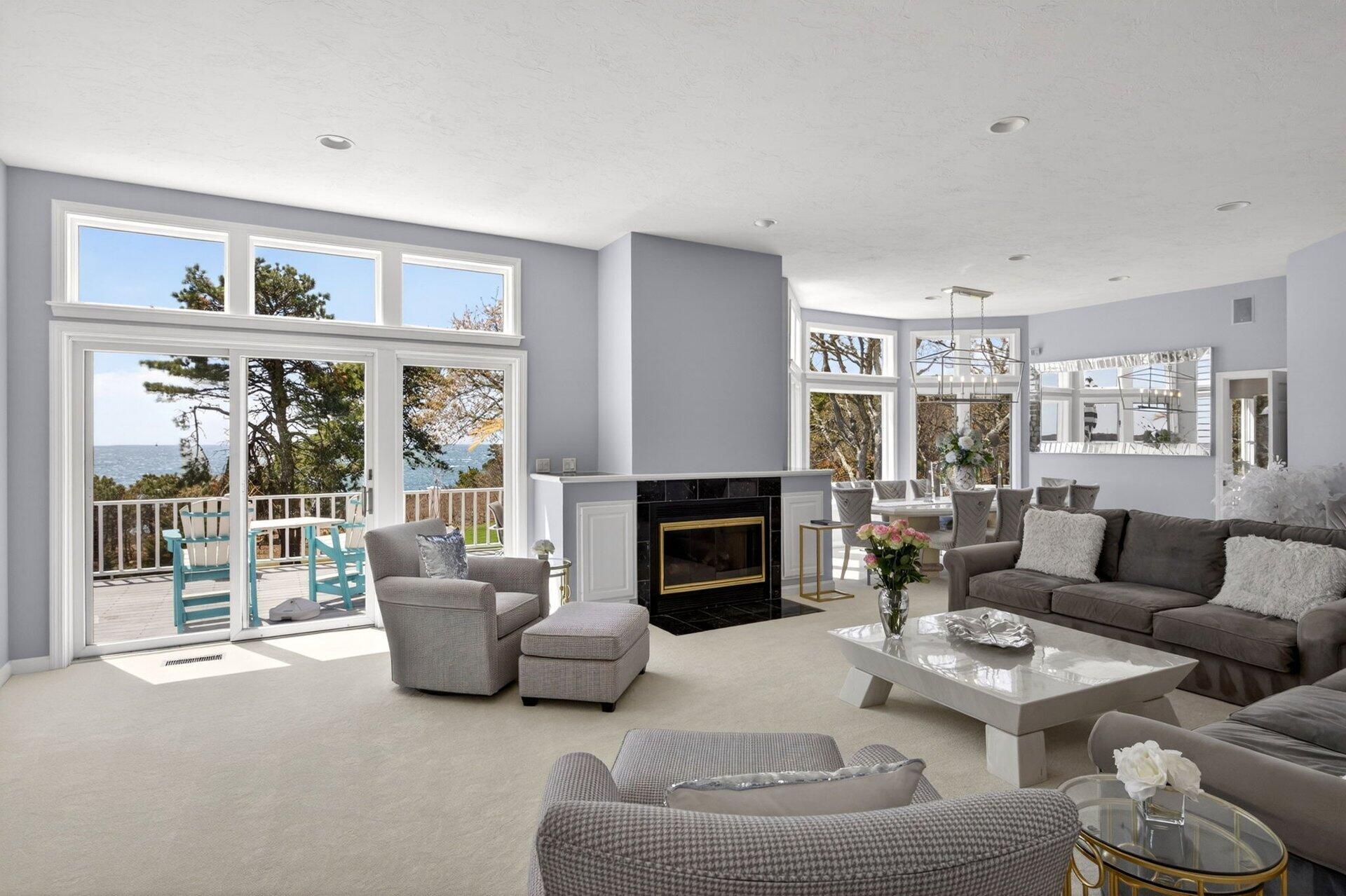 461 Wings Neck Road Pocasset, MA 02559 - Photo 13 of 42 a living room with furniture a fireplace and a large window