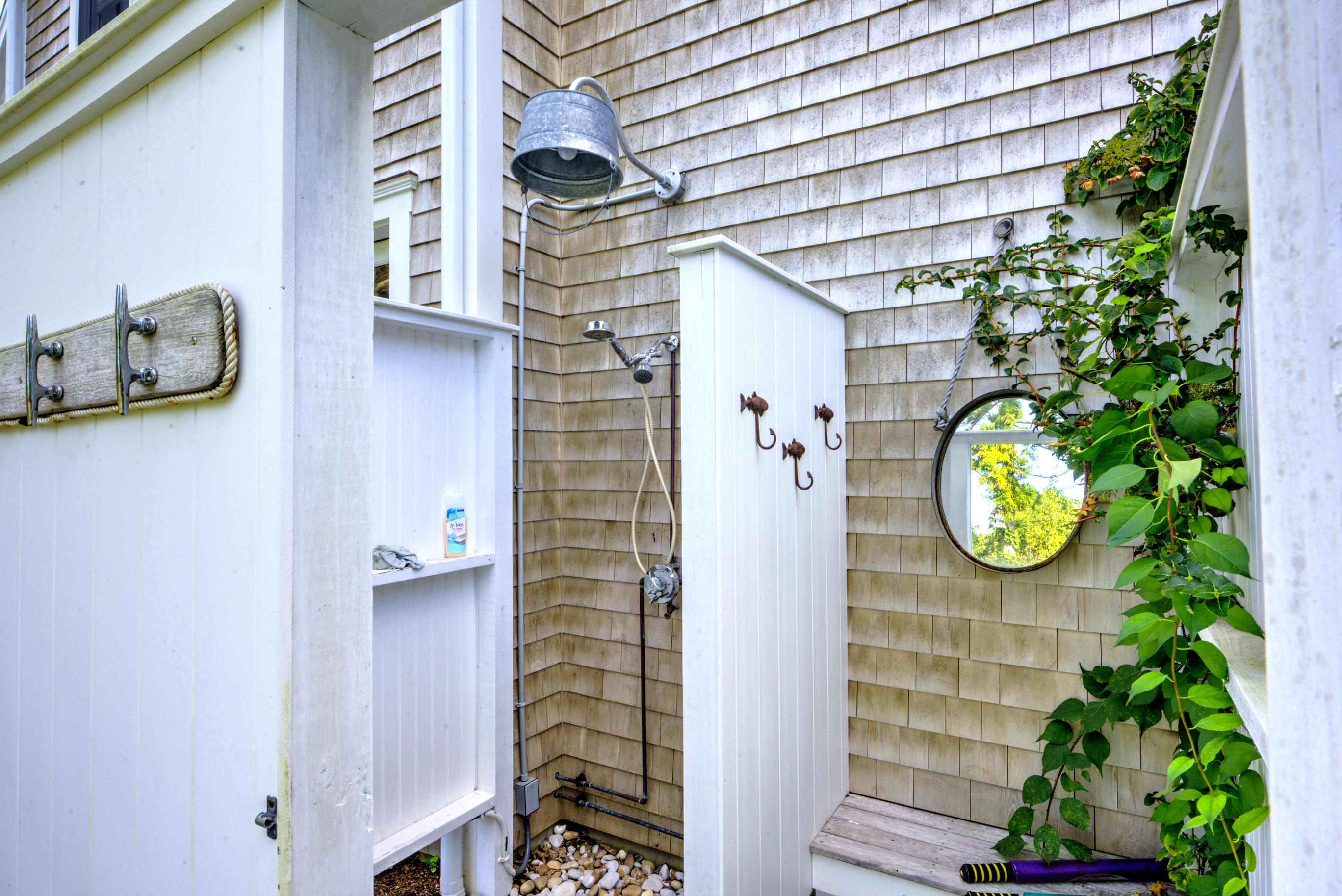 360 Main Street Osterville, MA 02655 - Photo 26 of 29 a view of a pathway of a house with potted plants and a wooden bench
