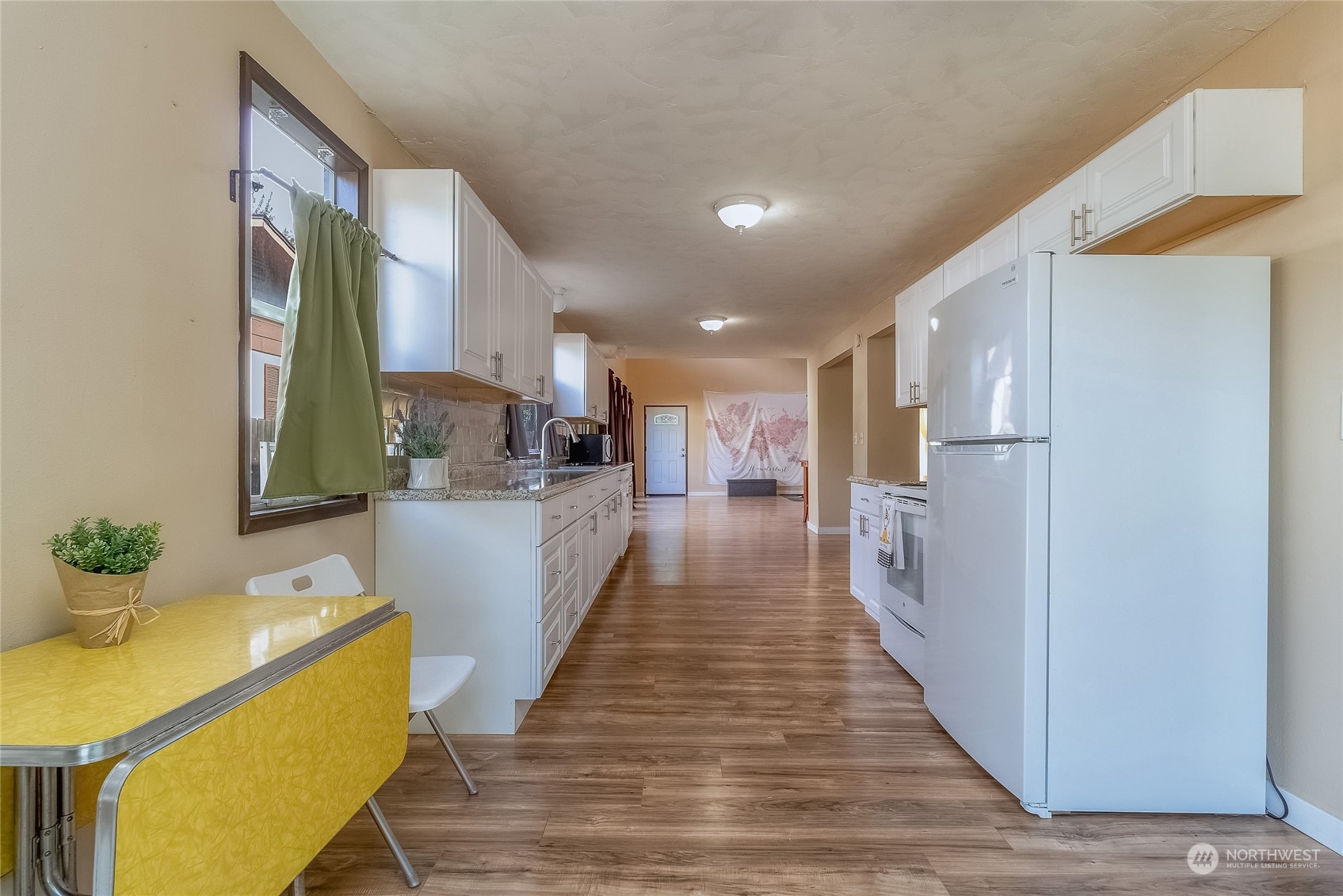326 Harrison Street Walla Walla, WA 99362 - Photo 12 of 28 a view of a kitchen with kitchen island wooden floor center island and stainless steel appliances