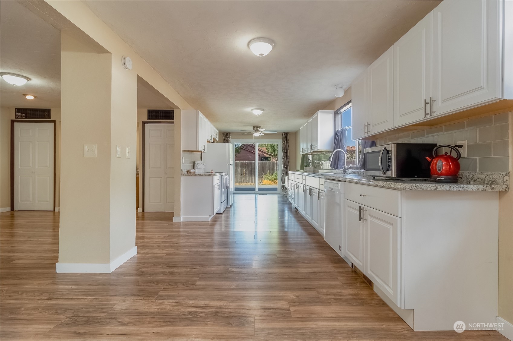 326 Harrison Street Walla Walla, WA 99362 - Photo 9 of 28 a large kitchen with stainless steel appliances kitchen island granite countertop a large counter top and a stove top oven