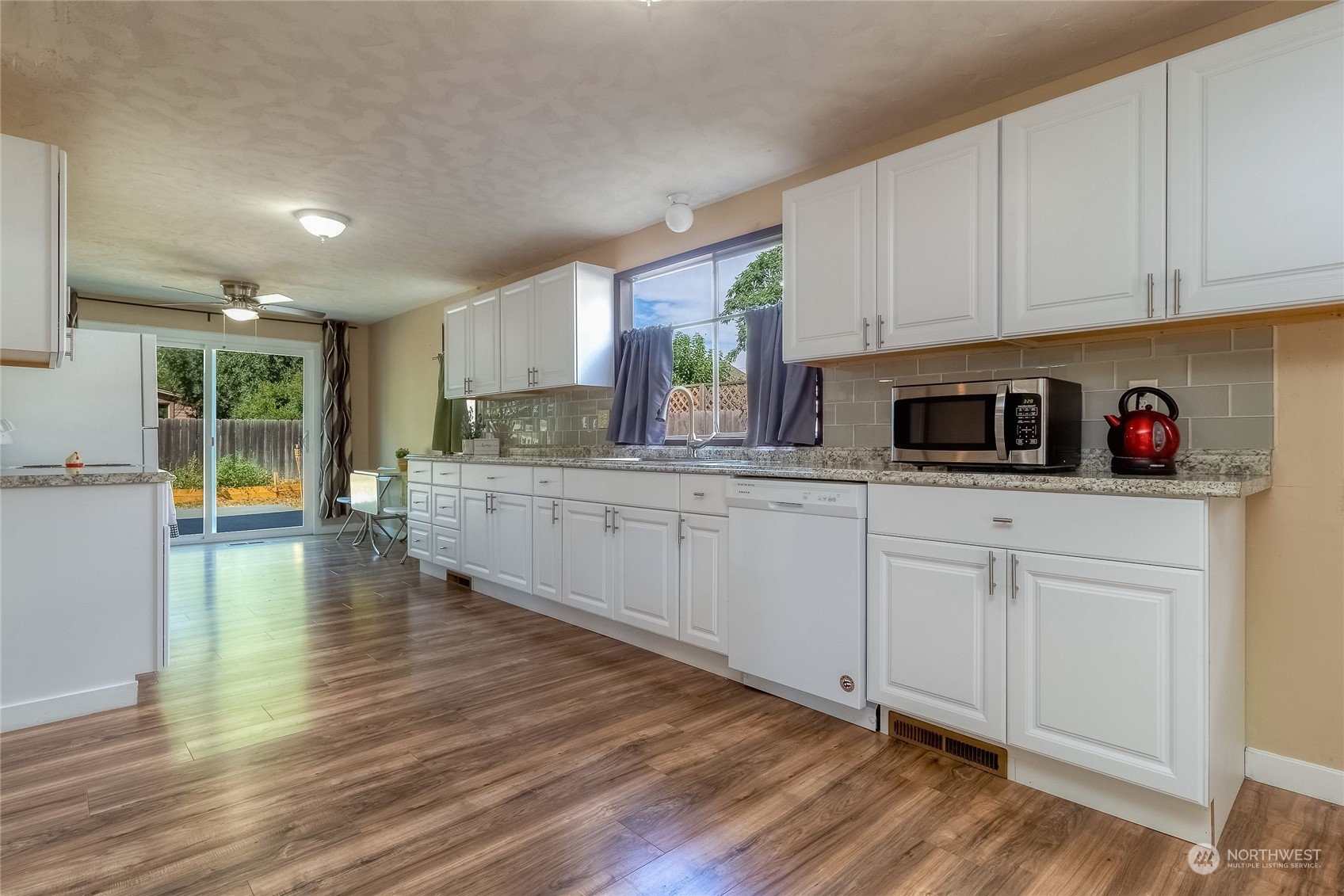 326 Harrison Street Walla Walla, WA 99362 - Photo 10 of 28 a kitchen with stainless steel appliances granite countertop a sink cabinets and wooden floor