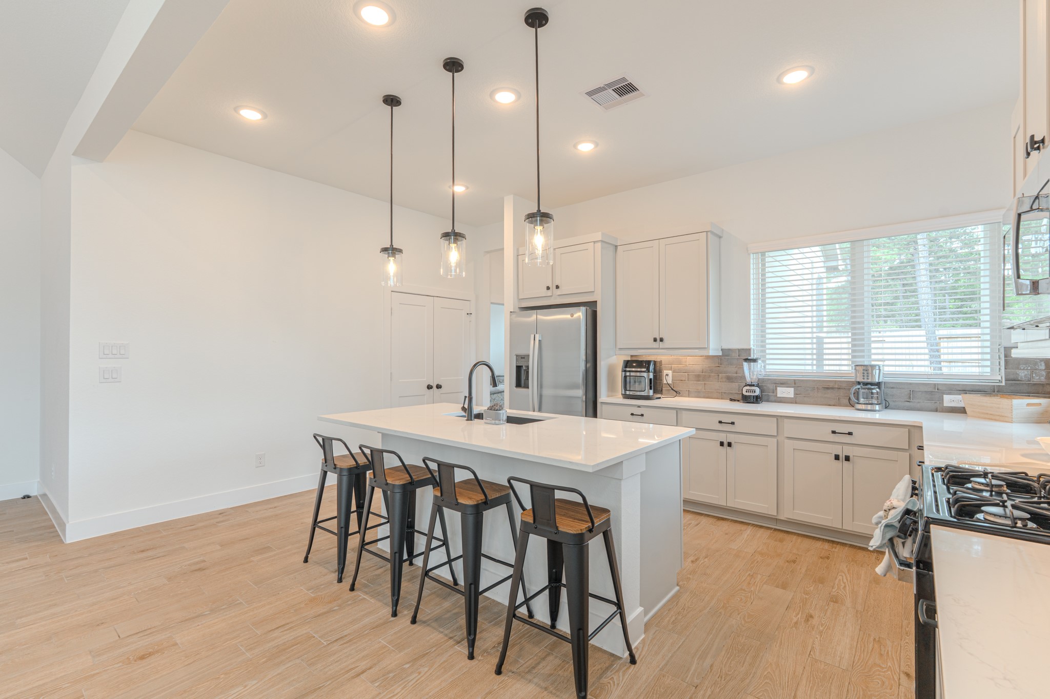 214 Prairie Rose Court Conroe, TX 77318 - Photo 13 of 30 a kitchen with a table chairs sink and cabinets