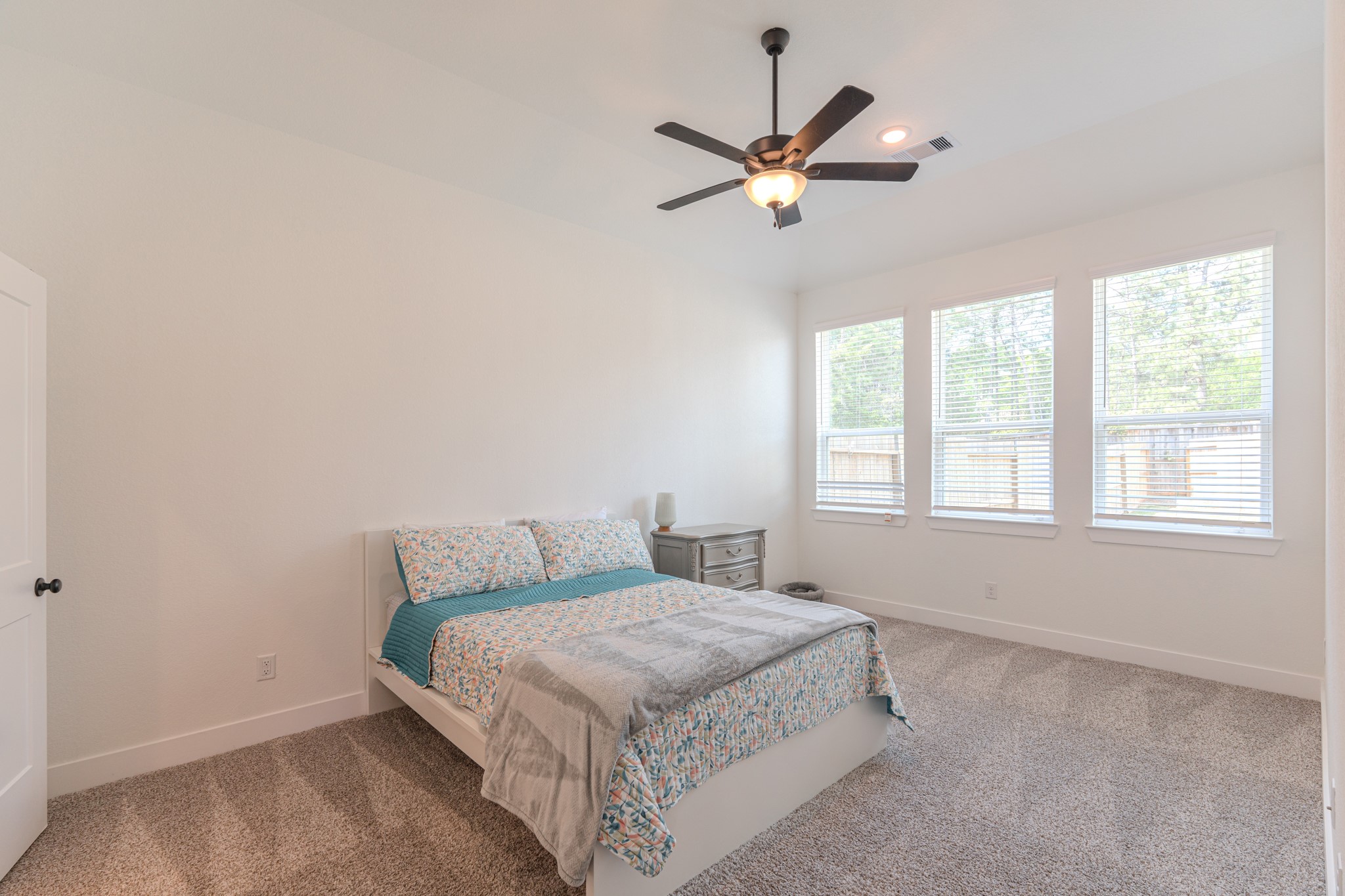 214 Prairie Rose Court Conroe, TX 77318 - Photo 16 of 30 a bedroom with a large bed and a window