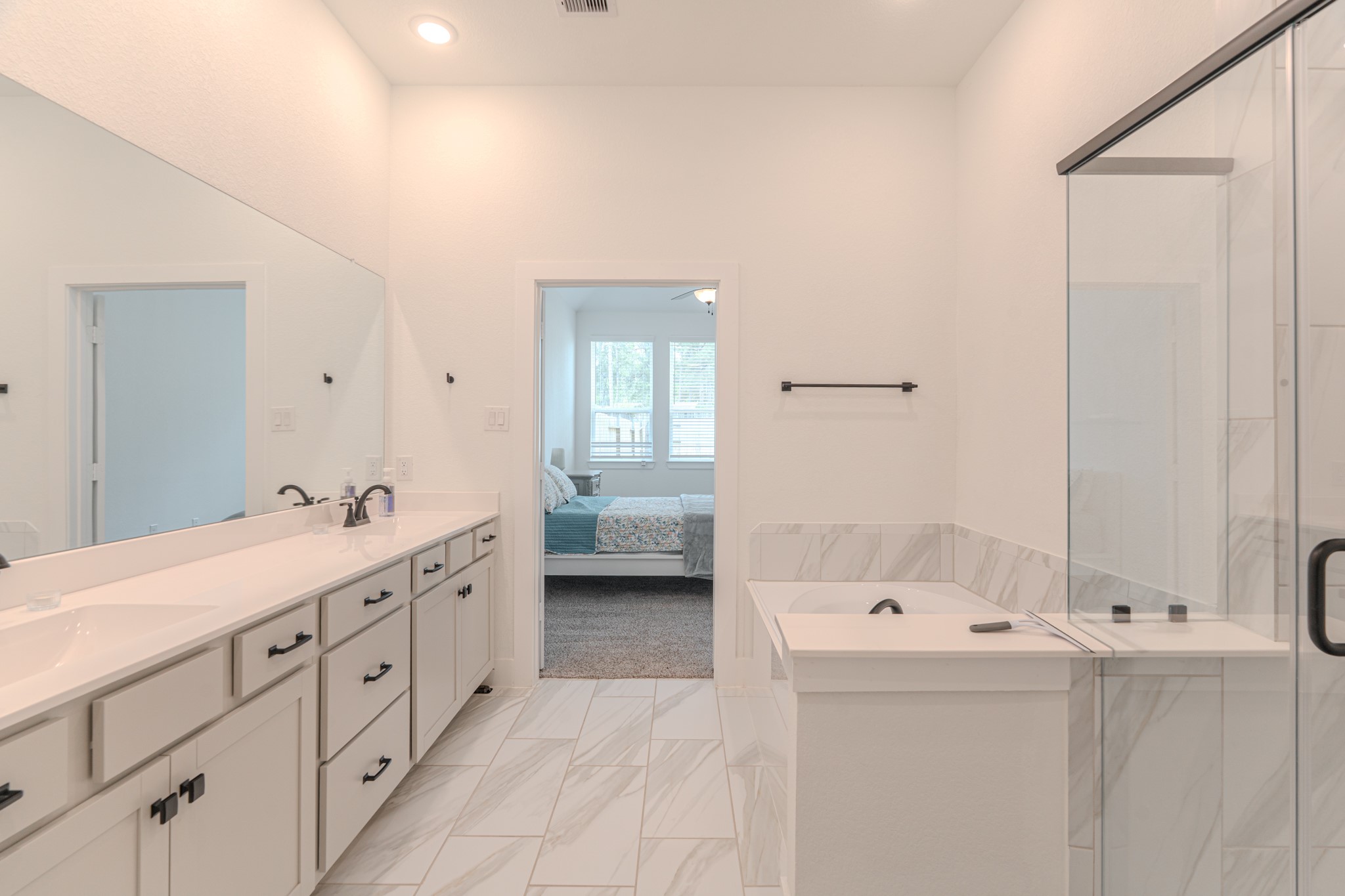 214 Prairie Rose Court Conroe, TX 77318 - Photo 19 of 30 a bathroom with a double vanity sink and mirror