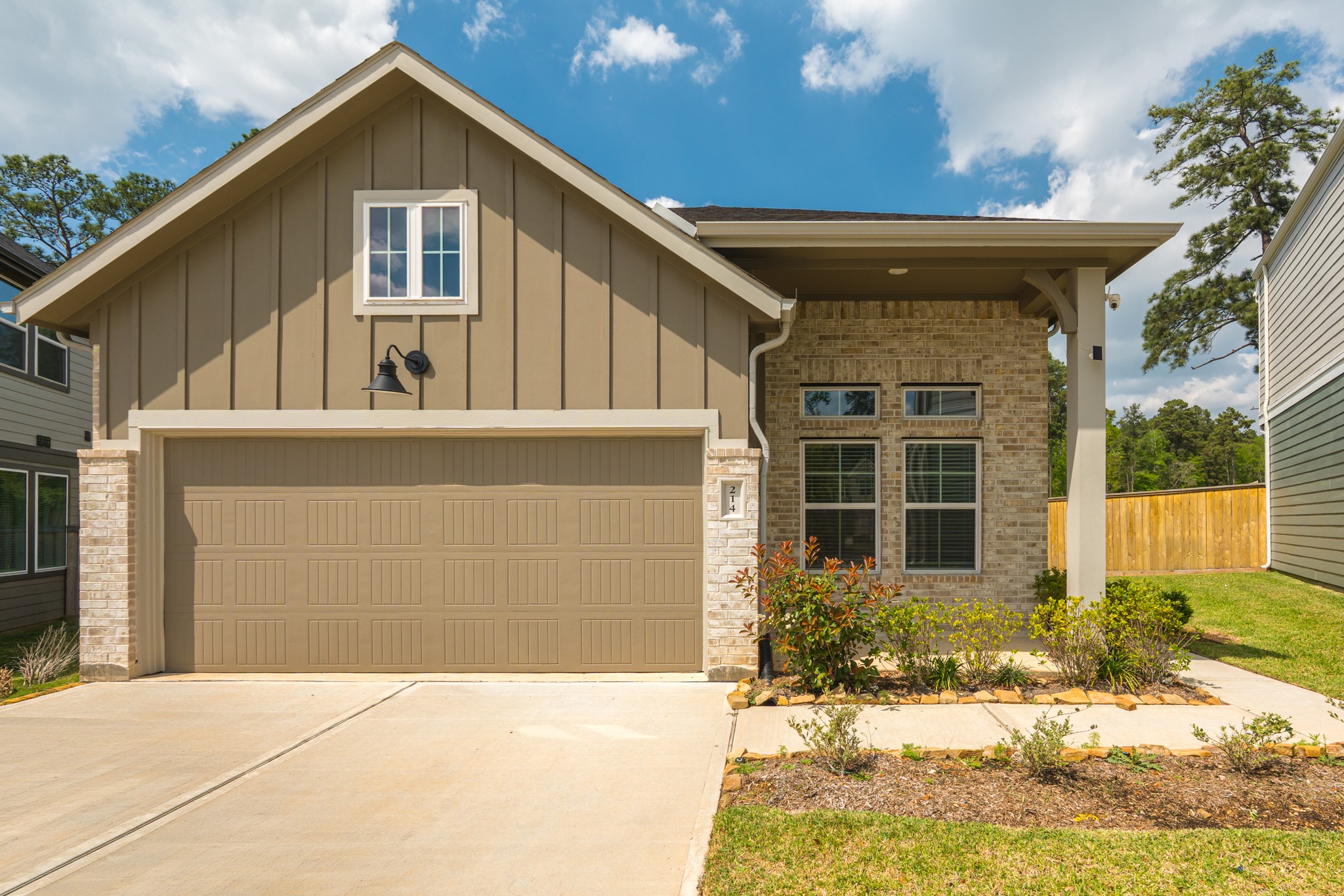 214 Prairie Rose Court Conroe, TX 77318 - Photo 2 of 30 a front view of a house with a yard