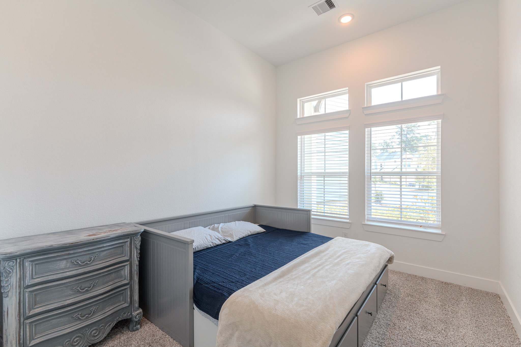214 Prairie Rose Court Conroe, TX 77318 - Photo 23 of 30 a bedroom with a bed and a window