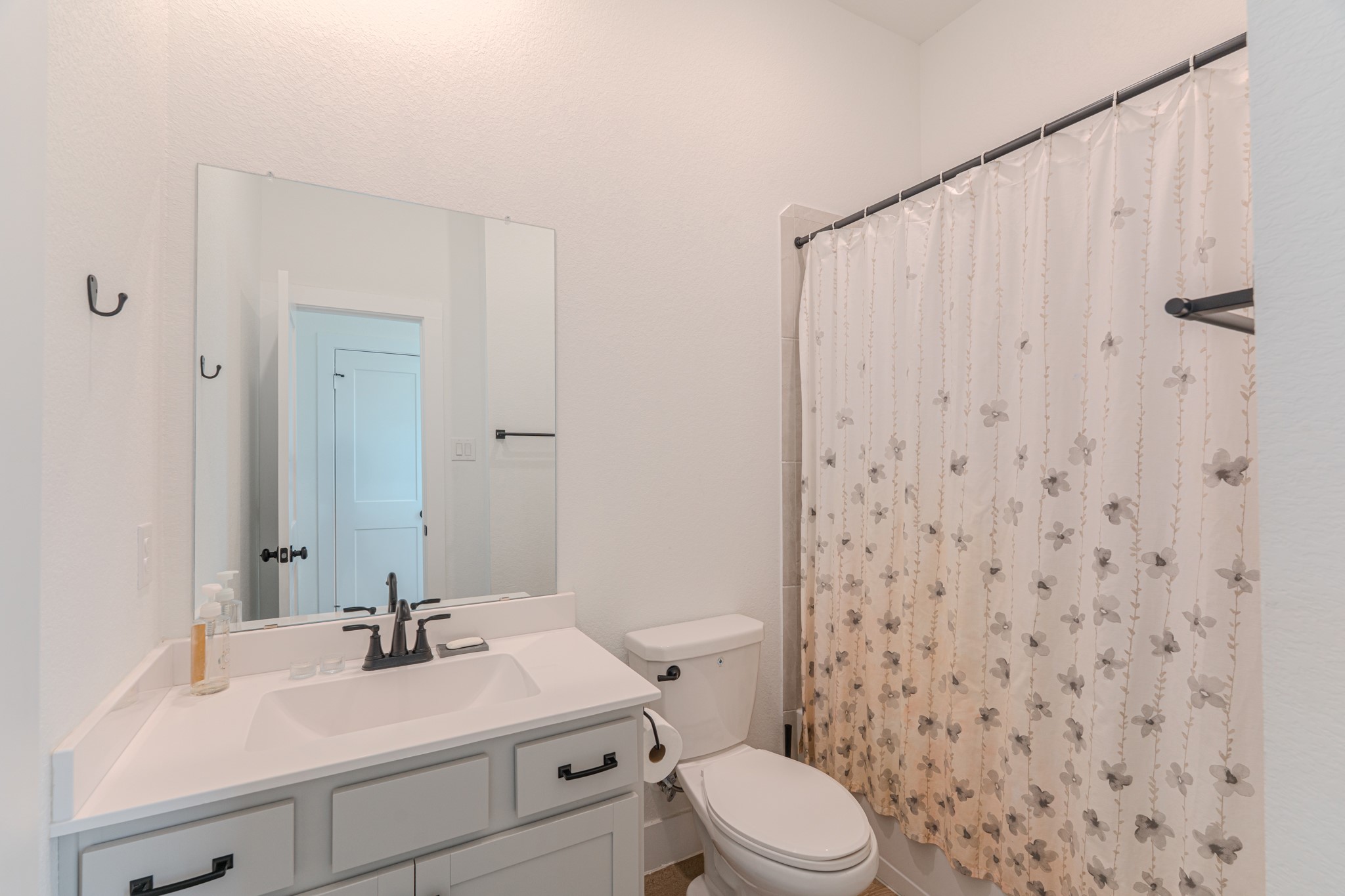 214 Prairie Rose Court Conroe, TX 77318 - Photo 25 of 30 a bathroom with a sink a toilet and shower
