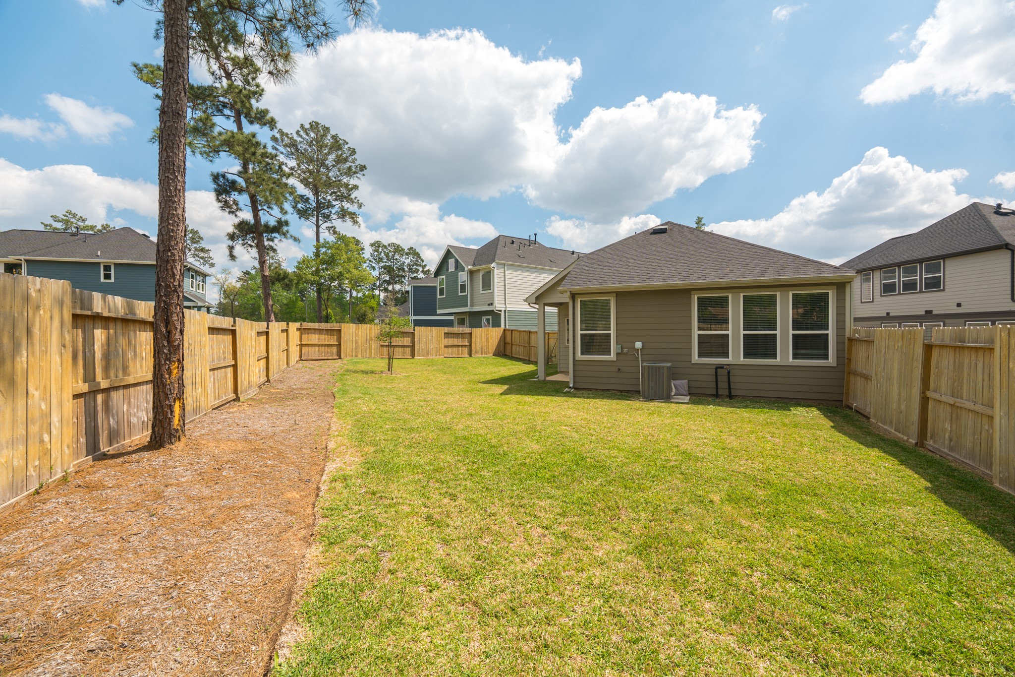 214 Prairie Rose Court Conroe, TX 77318 - Photo 30 of 30 a view of an house with swimming pool and a yard