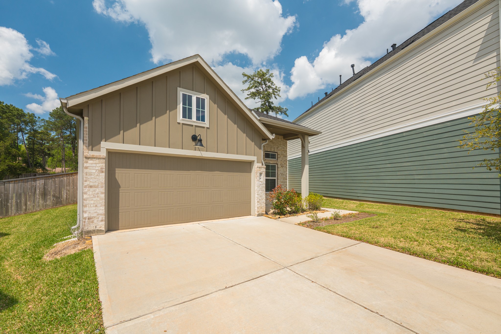 214 Prairie Rose Court Conroe, TX 77318 - Photo 3 of 30 a front view of a house with a yard and garage
