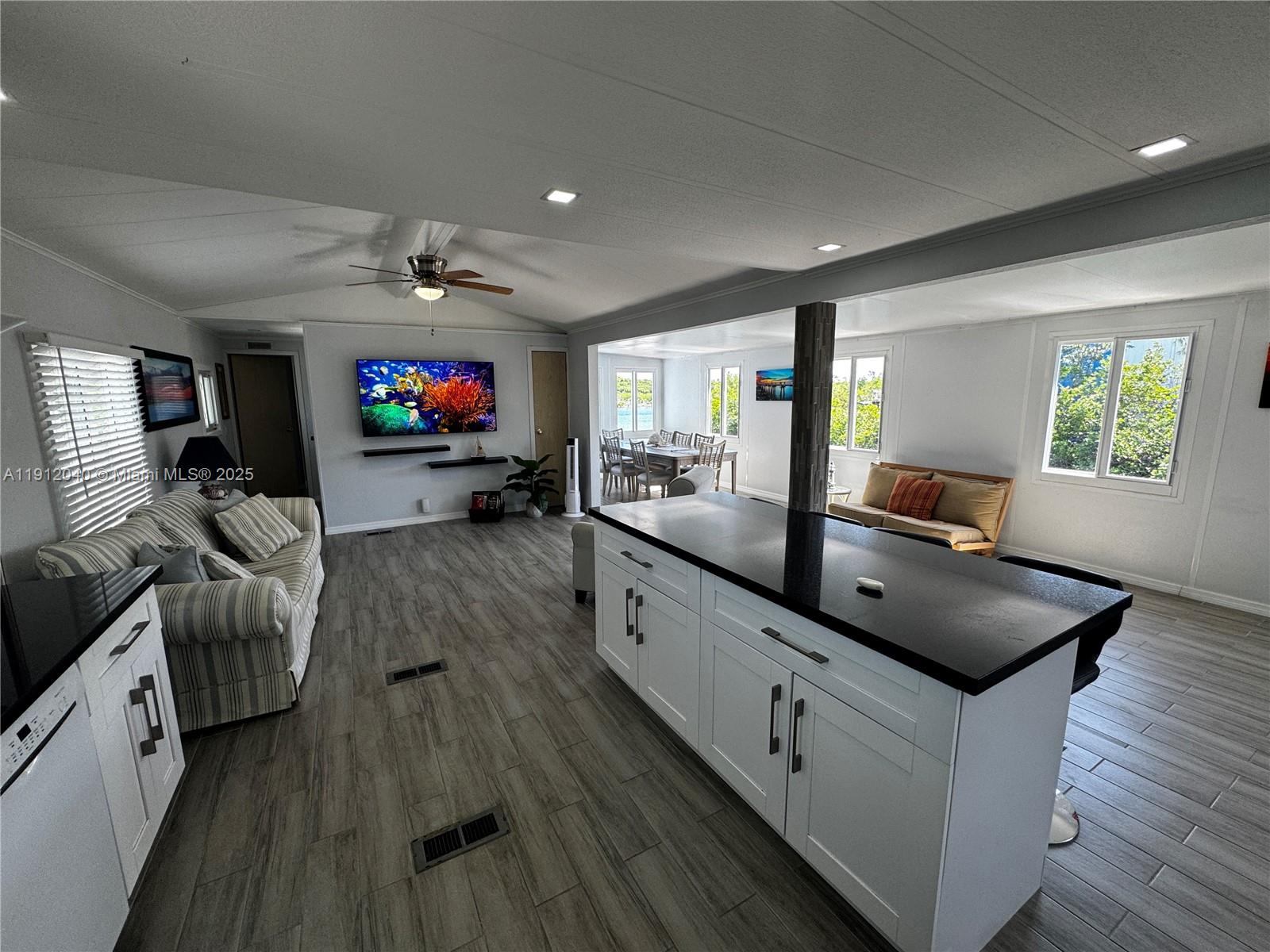 228 Orchid Street Tavernier, FL 33070 - Photo 12 of 43 a living room with furniture and a flat screen tv
