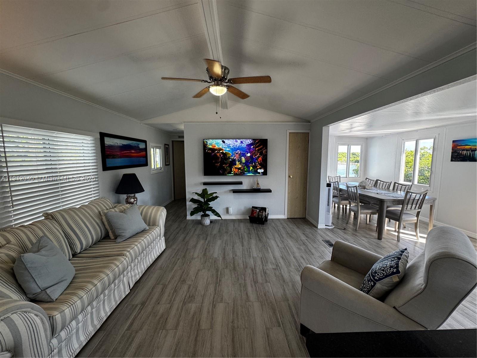228 Orchid Street Tavernier, FL 33070 - Photo 13 of 43 a living room with furniture a ceiling fan and a flat screen tv
