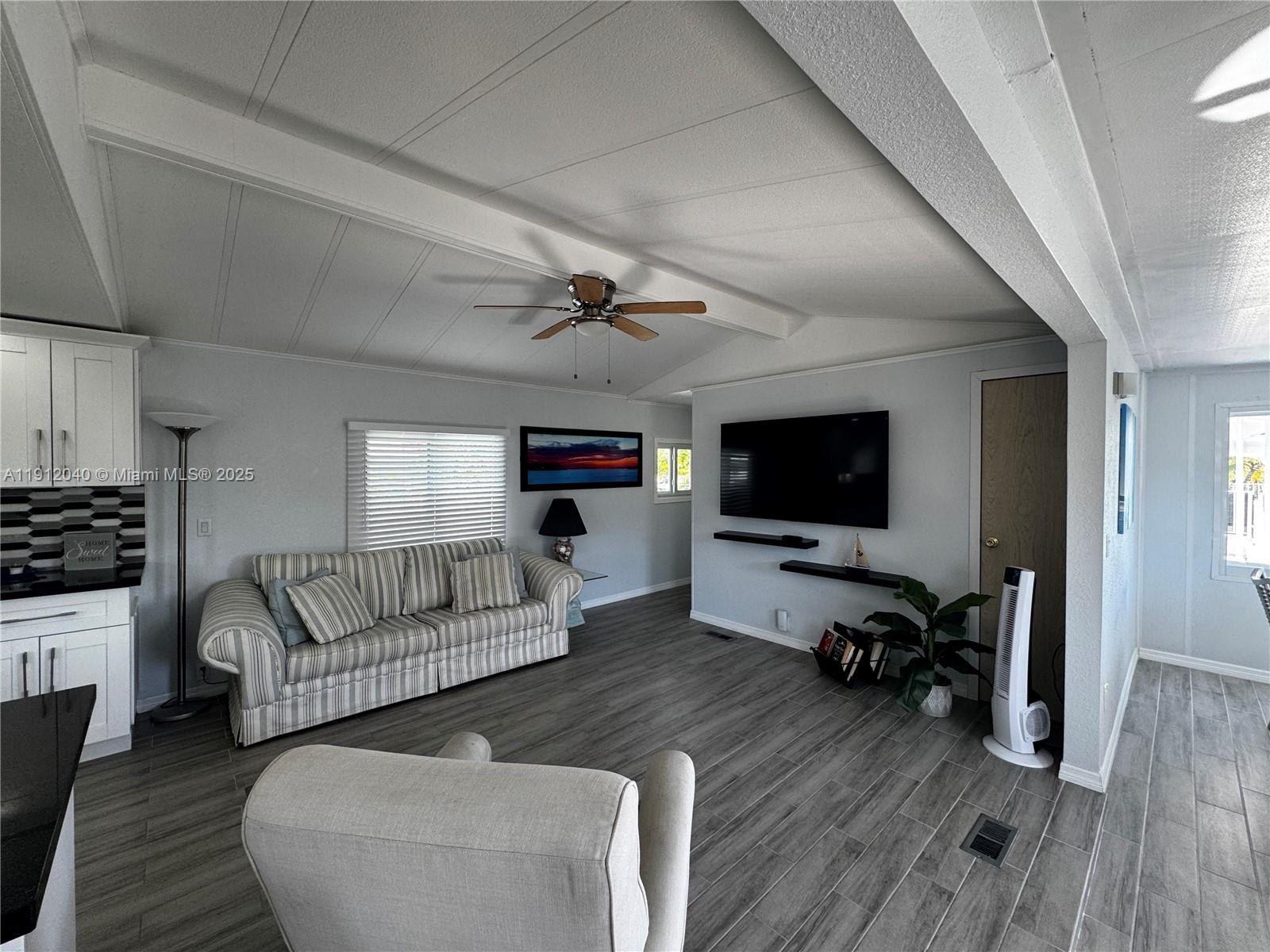 228 Orchid Street Tavernier, FL 33070 - Photo 14 of 43 a living room with furniture flat screen tv and wooden floor