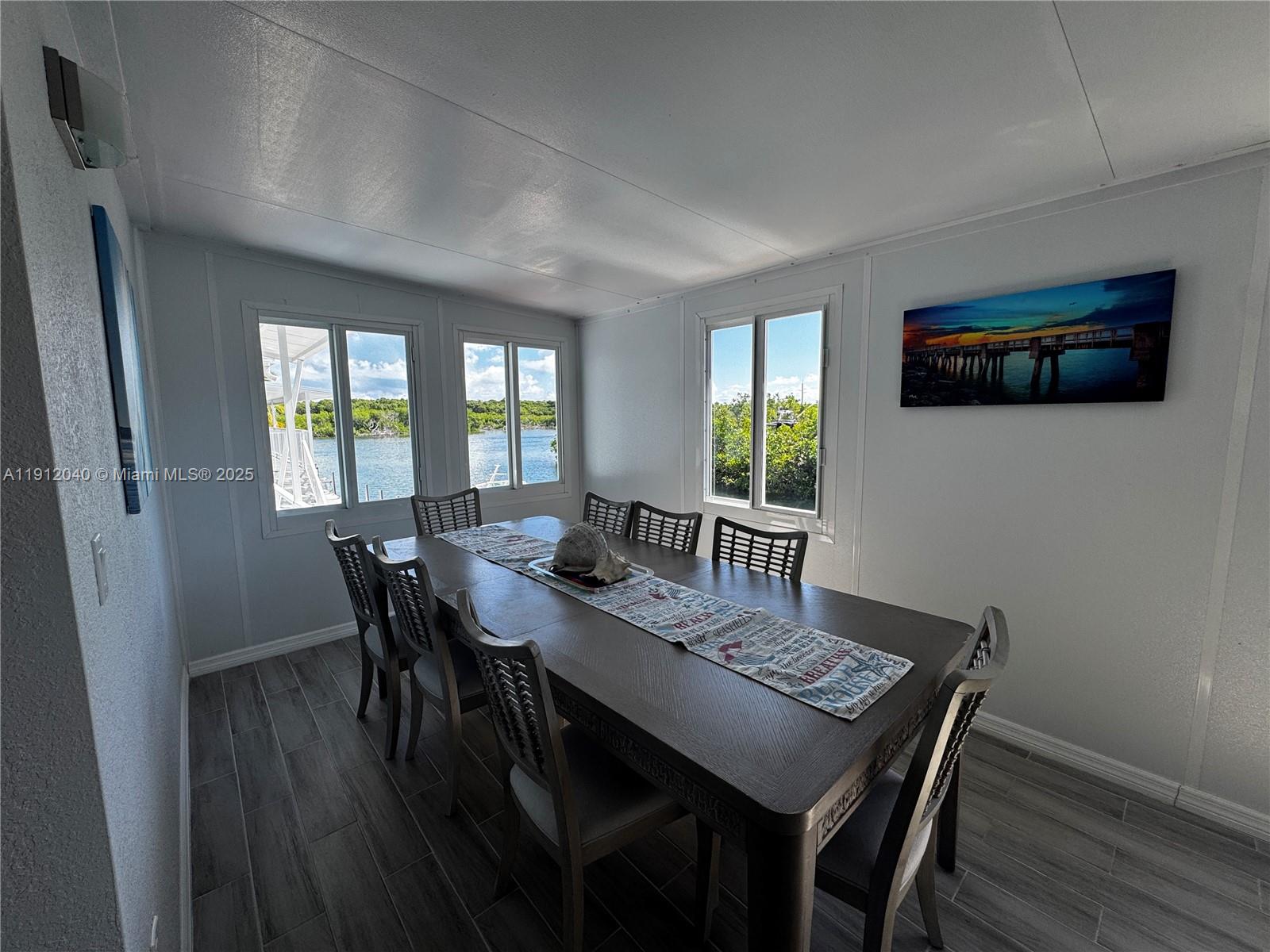 228 Orchid Street Tavernier, FL 33070 - Photo 16 of 43 a view of a dining room with furniture and wooden floor