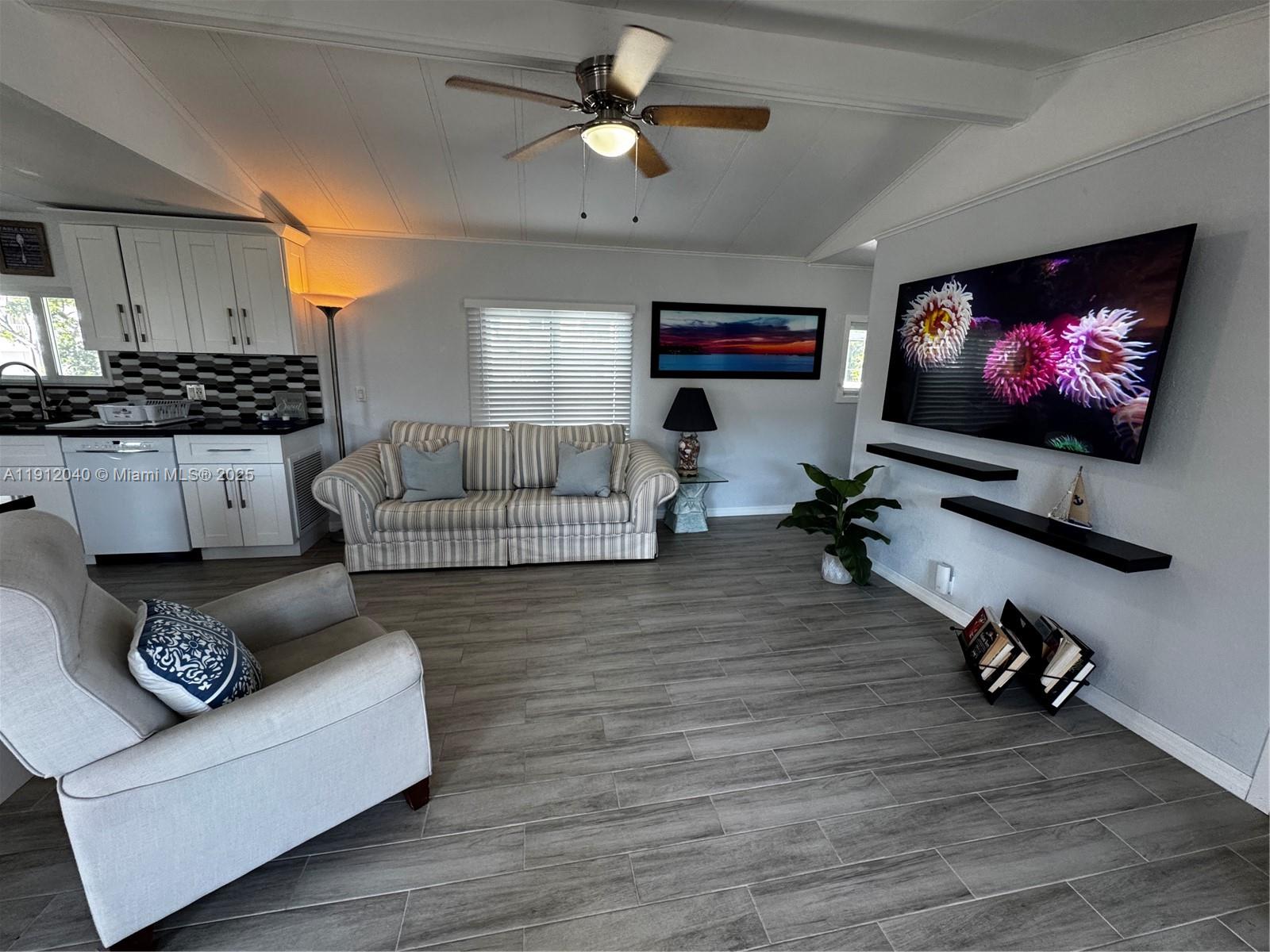 228 Orchid Street Tavernier, FL 33070 - Photo 17 of 43 a living room with furniture and a flat screen tv