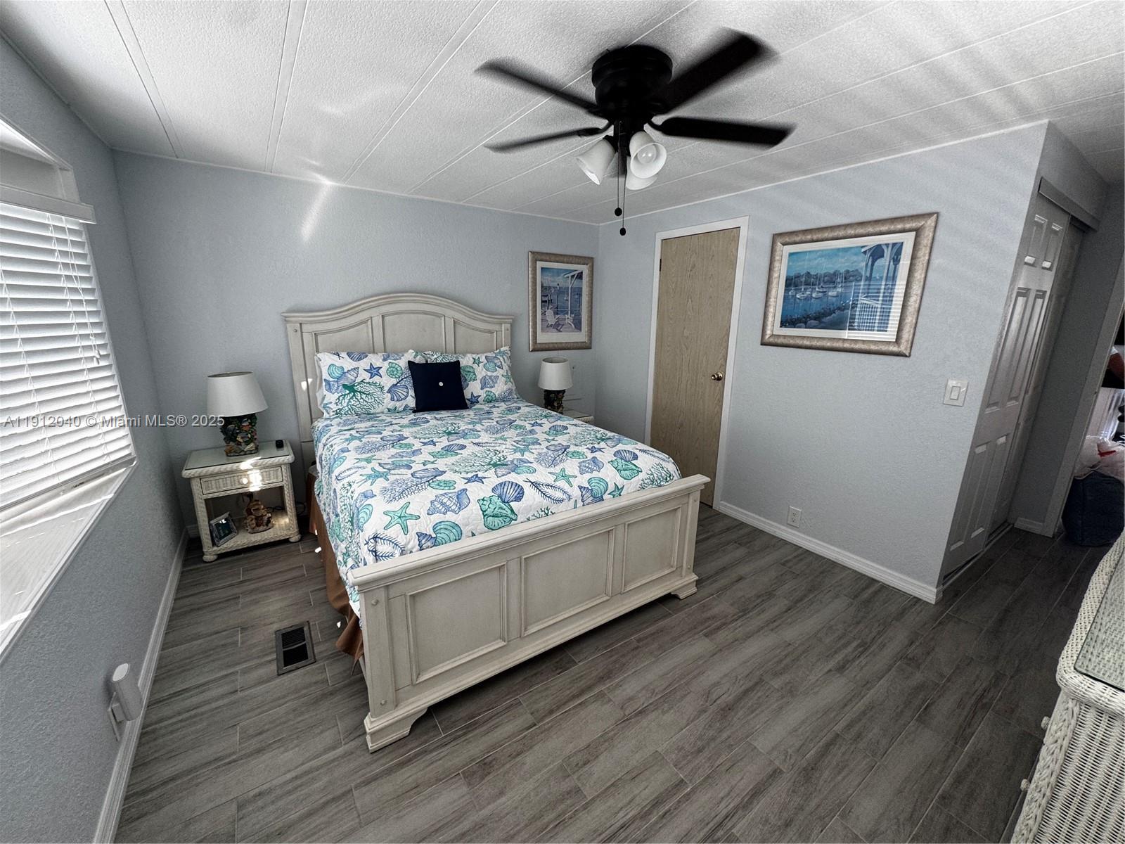 228 Orchid Street Tavernier, FL 33070 - Photo 19 of 43 a bedroom with a bed and a chandelier