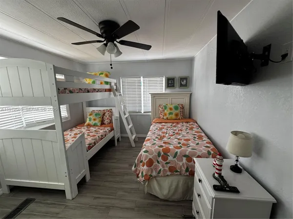 a bedroom with furniture and a flat screen tv
