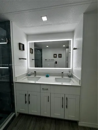 a bathroom with a granite countertop sink double and mirror