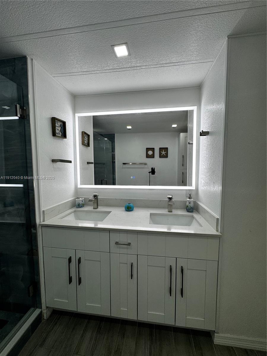 228 Orchid Street Tavernier, FL 33070 - Photo 27 of 43 a bathroom with a granite countertop sink double and mirror