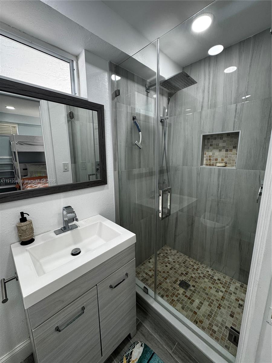 228 Orchid Street Tavernier, FL 33070 - Photo 30 of 43 a bathroom with a sink shower and a mirror