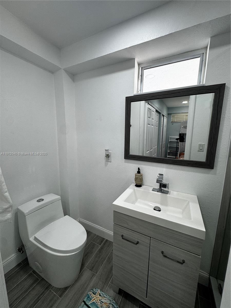 228 Orchid Street Tavernier, FL 33070 - Photo 31 of 43 a bathroom with a toilet sink and mirror