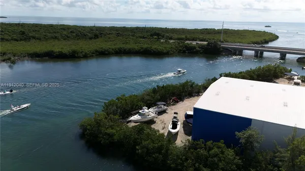 an aerial view of a house with a yard and lake view