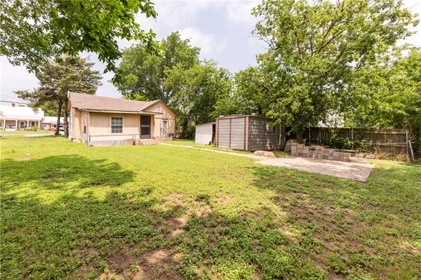 a view of house with outdoor space and garden